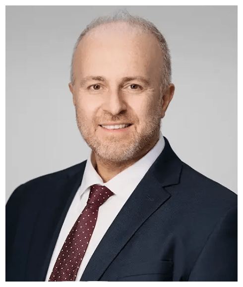 Weston prosthodontist Doctor Konstantinos Vazouras smiling in professional clothing