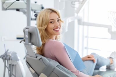 Woman smiling at her dental checkup.